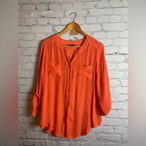 Fun orange blouse with front pockets!